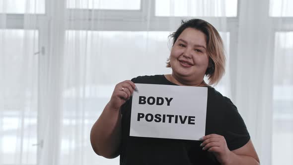 Concept Body Positivity a Chubby Smiling Woman Holds a Sign with the Inscription BODY POSITIVE