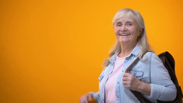 Joyful Retiree Woman Showing Passport and Tickets, Preparing for Travel Tour