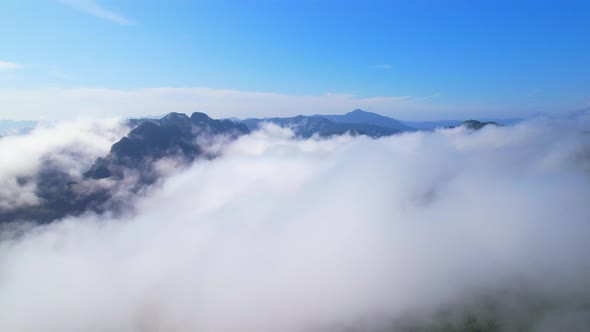 Aerial top view from drone above the mountain fog in the morning