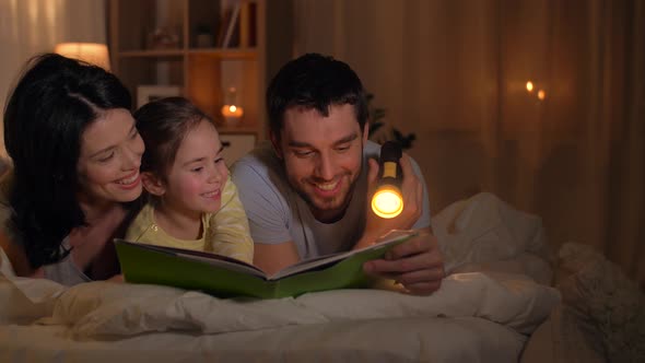 Happy Family Reading Book in Bed at Home 30