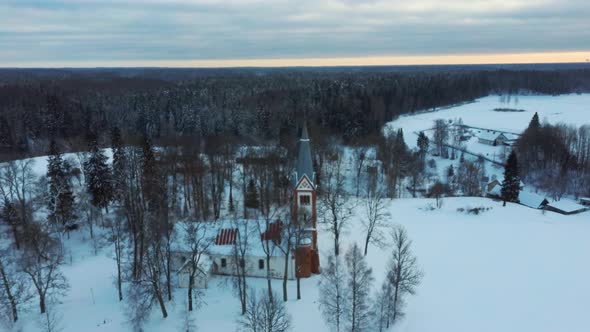 Aerial Top View of the Krimulda Evangelic Lutheran Church in Winter at Sunrise Latvia 4k Video