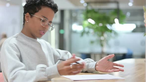 Casual African Woman Trying to Write on Paper