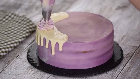 Chef Decorating Cake with a cream.	