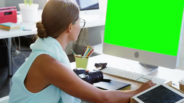 Female graphic designer working on computer