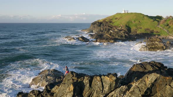 fisherman rock fishing at tacking point lighthouse