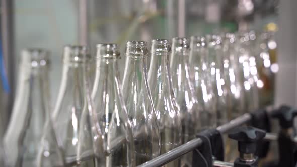 Conveyor Line with Moving Empty Clean Transparent Bottles. Beverage Production Line.