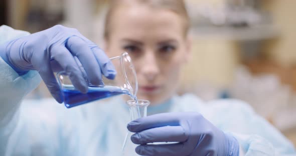 Scientist Mixing Liquid at Laboratory