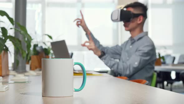 Cup of Coffee on the Table Man Using 3d Vr Glasses at Work on the Background