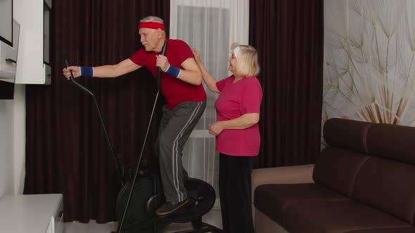 Senior Man in Sportswear Using Orbitrek in Living Room Doing Sport Training Cardio Exercises at Home