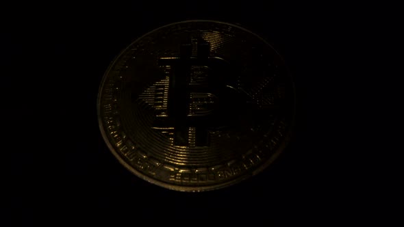 Gold Bitcoin on Black Surface. Light Reflect To Digital Coin. Blockchain Technology. Crypto Market