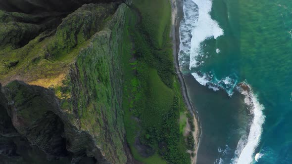 Beautiful Green Mountains with Steep Cliffs and Stormy Beach Aerial Hawaii
