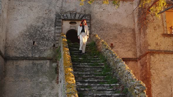 Young girl on the entrance stairway to the castle