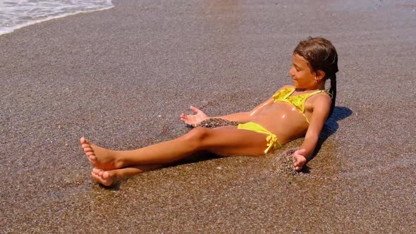 The Child is Lying on the Beach