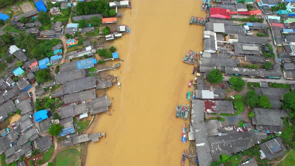 Aerial shot of river and local fisherman village beside the sea