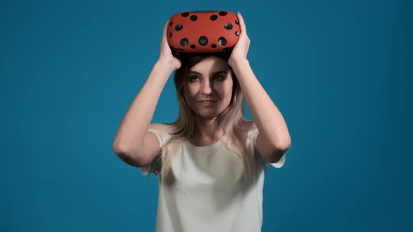 Woman in T-shirt Puts on Virtual Reality Headset To Play