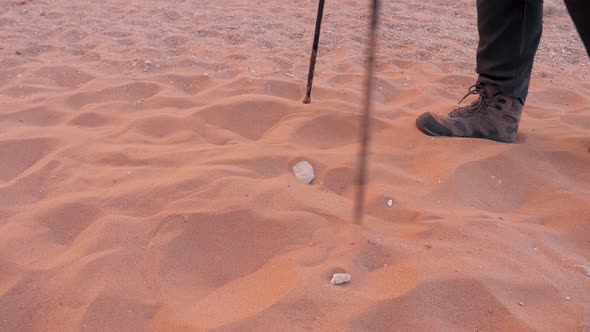 Feet In Boots Tired Exhausted Traveler Trudge Through The Dry Sandy Desert