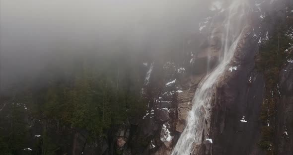 Aerial view of approaching waterfalls in misty weather, variation