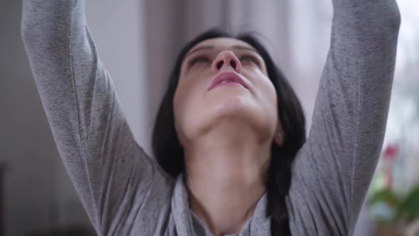 Close-up Face of Young Beautiful Caucasian Woman Raising Hands Up, Putting Them Together and Putting