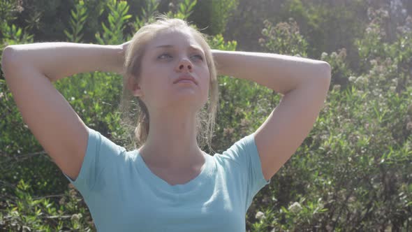 A young woman runner resting after jogging.