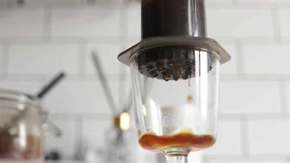 Barista Makes Aeropress Step By Step. Close Up Coffee Squeezing. Droplets.