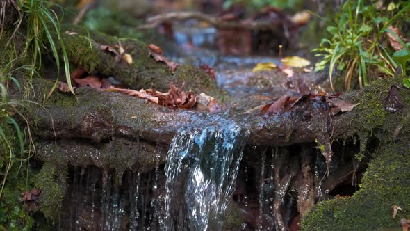 Water stream falling from pile of rocks