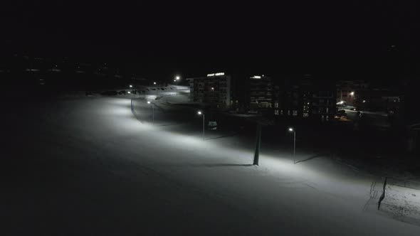 Flying at night over rope-way with gondolas at mountain resort Crystal Park in Bakuriani. 