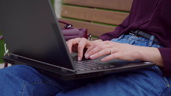 Close up woman hands working with laptop