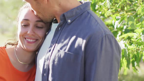 Happy caucasian young couple hugging and spending time outside