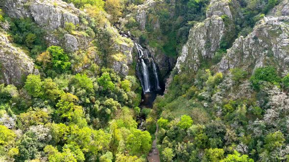 Aerial Drone View Of Fervenza do Toxa Waterfalls Cascading Down Rockface In Lush Galicia Region of n