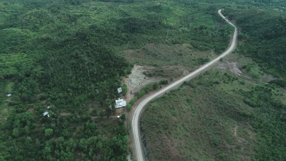 Aerial View of Countryside Road Passing Through the Lush Greenery and Foliage Tropical Rain Forest