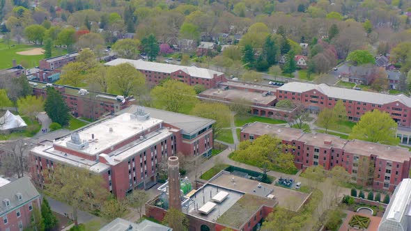 Wide aerial panorama of college housing on university campus. Large red brick buildings house studen