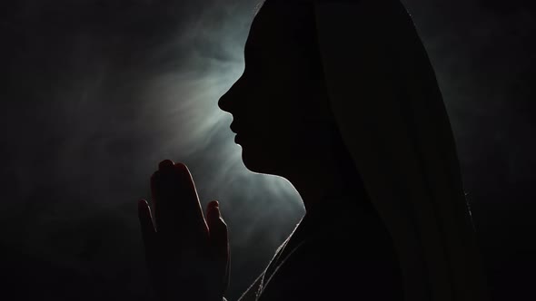 Nun Praying in a Dark Place