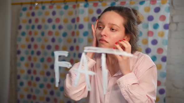 Bulimic Young Woman Looking Into Mirror with Fat Inscription and Touching Face