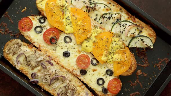 Composition of Hot Tasty Baked Sandwiches with Various Toppings. Cheese, Tuna, Mozarella, Spices