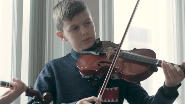 Boy playing violin during lesson