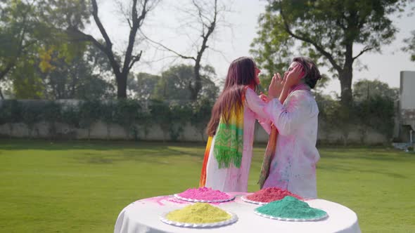 Cute Indian couple playing Holi