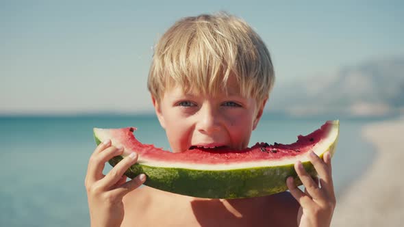 Boy Eating Watermelon on the Beach Summertime