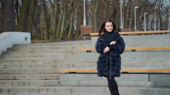 Beautiful model posing on camera in autumn park. 