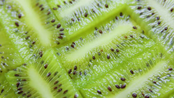 Green Citrus Fruit Slices of Kiwi on Rotating Surface