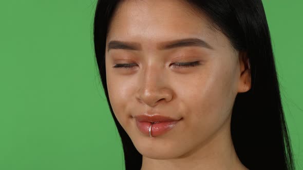 Sliding Shot of a Asian Woman Smiling To the Camera