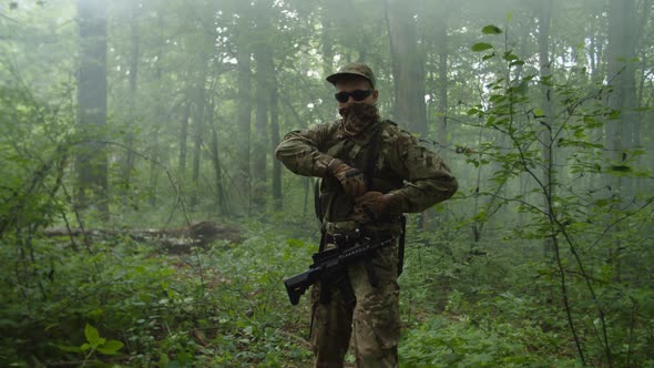 Military Man Observing Enemy Position Throwing Hand Grenade in Forest