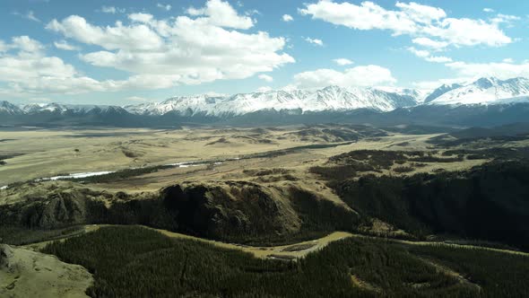 Mountainous Terrain with Blue Skies and Gray Clouds