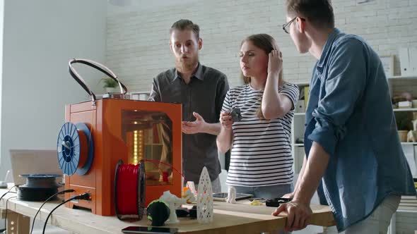 Team of Engineers Watching Process of 3D Printing