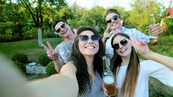 Attractive Young Woman Is Taking Selfie with Friends on Birthday Party, Girl Is Holding Camera