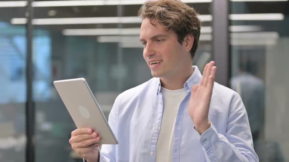 Portrait of Video Call on Tablet By Man in Office