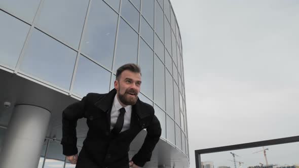 Businessman Jumping for Joy on the Street