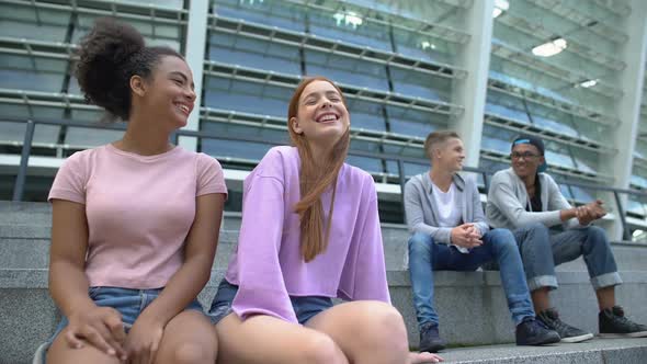 Teen Boys and Girls Laughing, Sitting Separately at School Stadium, Awkward Age