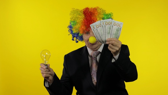 Clown Businesswoman Show Light Bulb. Came Up with Great Idea and Receive Money