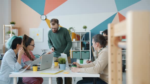 Cheerful People Professional Designers Discussing Business Ideas in Office