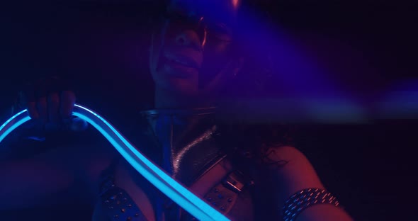 Glowing Blue Light African American Woman with an LED Strip in Hand Posing